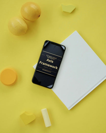 Phone displaying 'Tennixer Axis Framework' on a yellow surface with geometric shapes