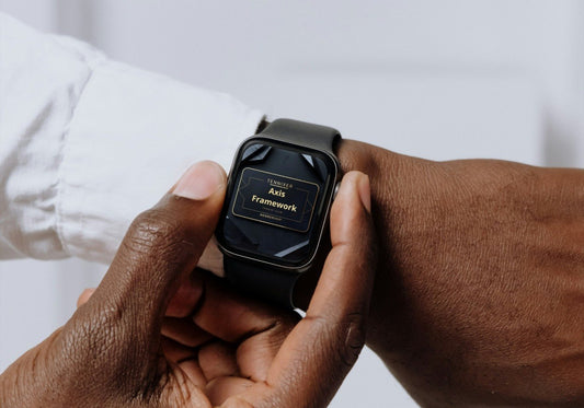 Person holding a smartwatch with a blurred background