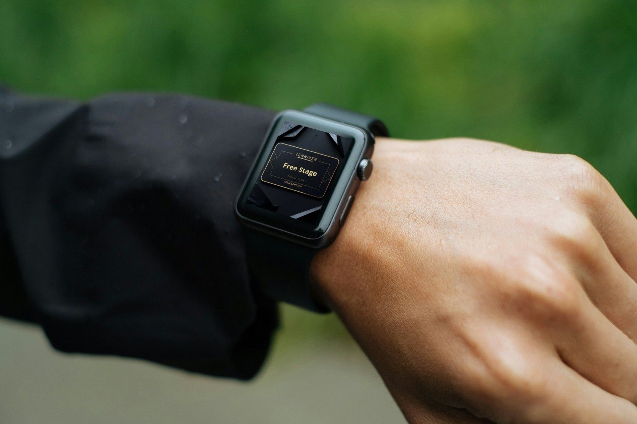 Smartwatch on a wrist with a blurred green background