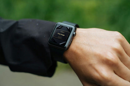 Smartwatch on a wrist with a blurred green background