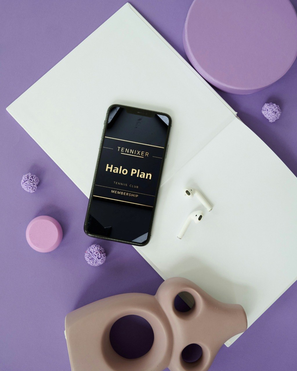 Phone displaying 'Tennixer Halo Plan' on a purple surface with minimal decor