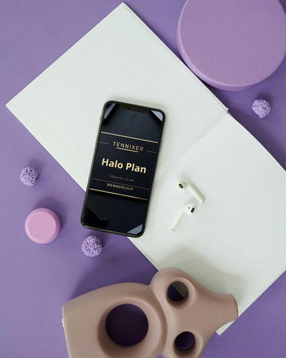 Phone displaying 'Tennixer Halo Plan' on a purple surface with minimal decor